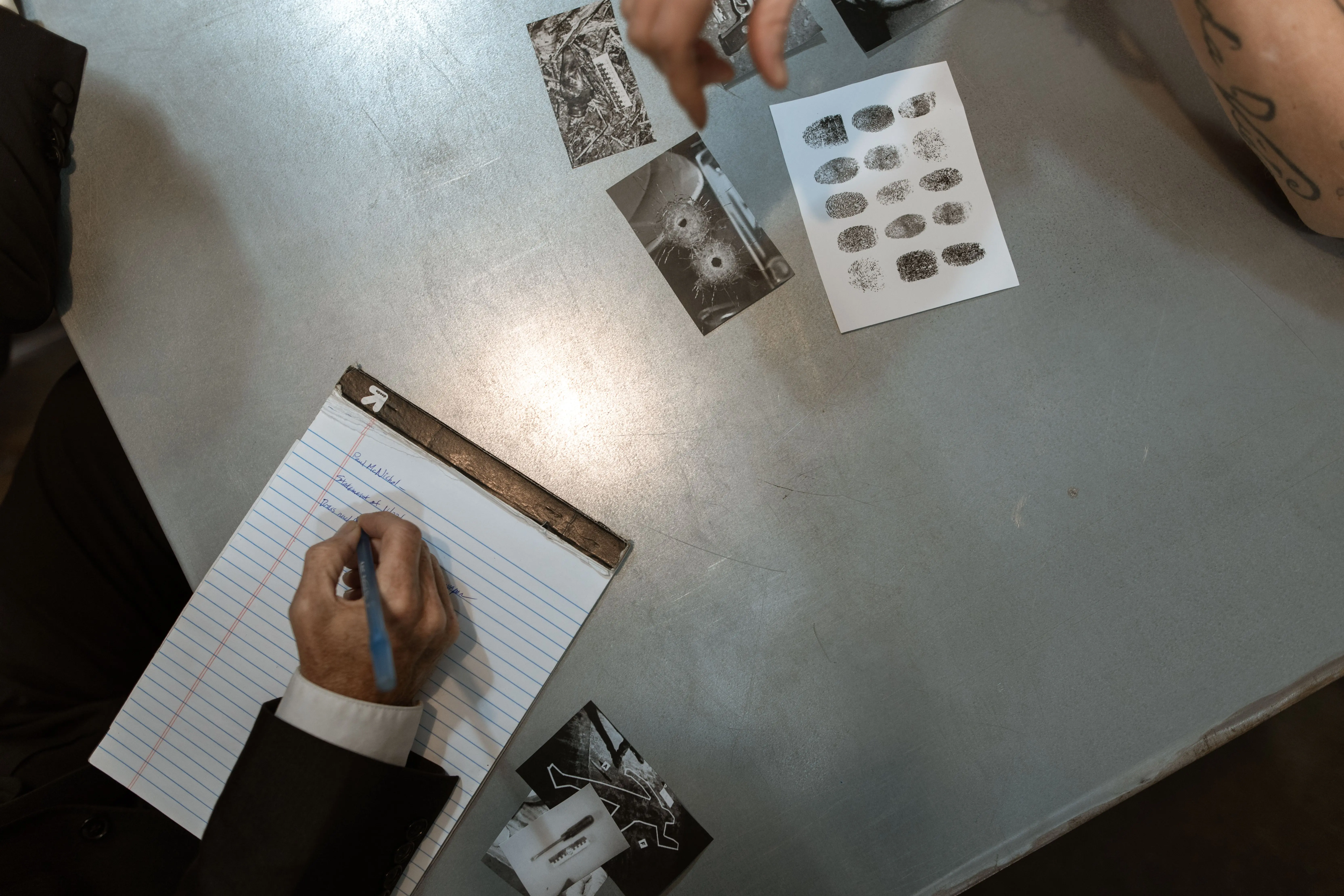Insurance investigation evidence including fingerprints, case photographs and written notes