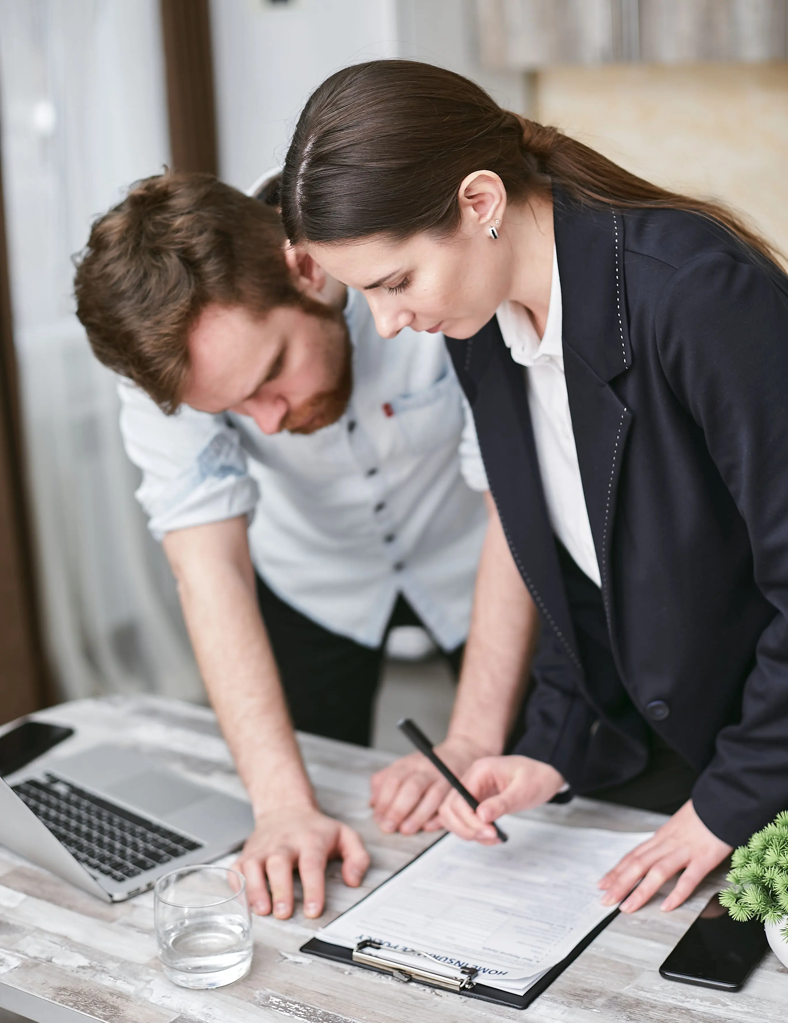 Insurance professionals reviewing case documents and policy paperwork together