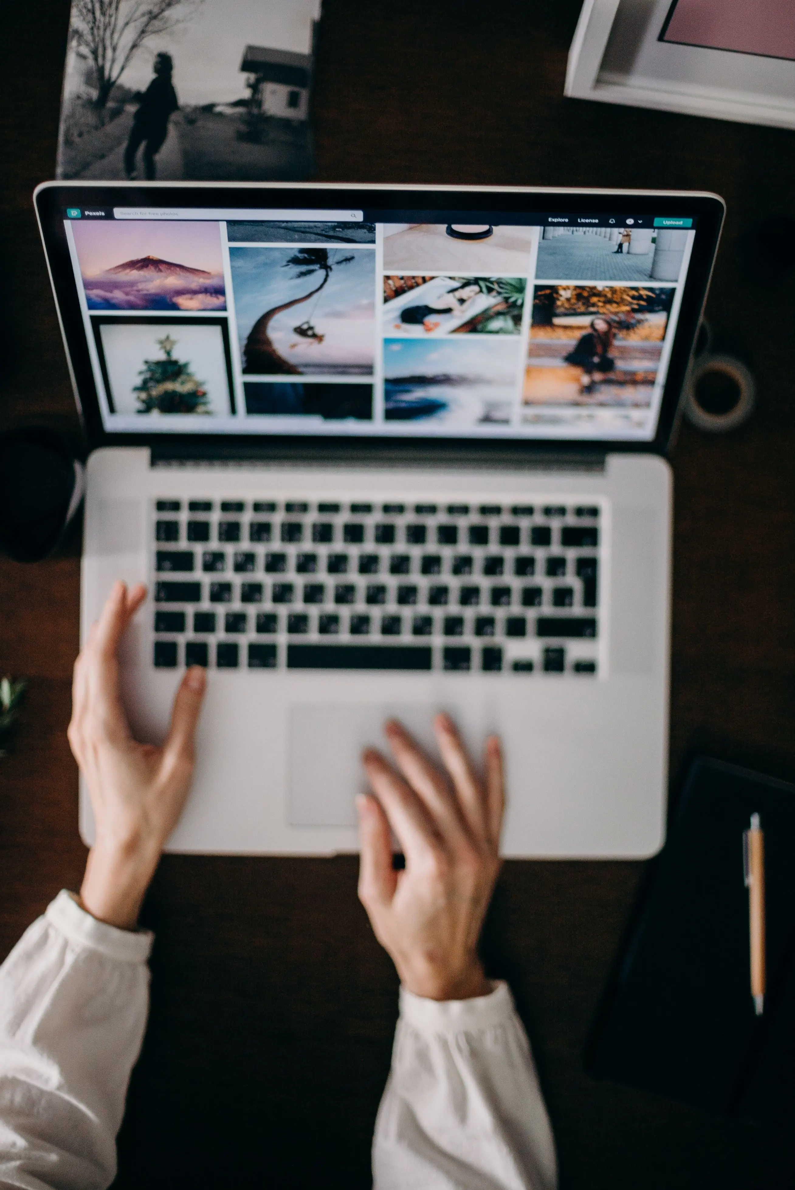 Person using laptop to browse digital image collections