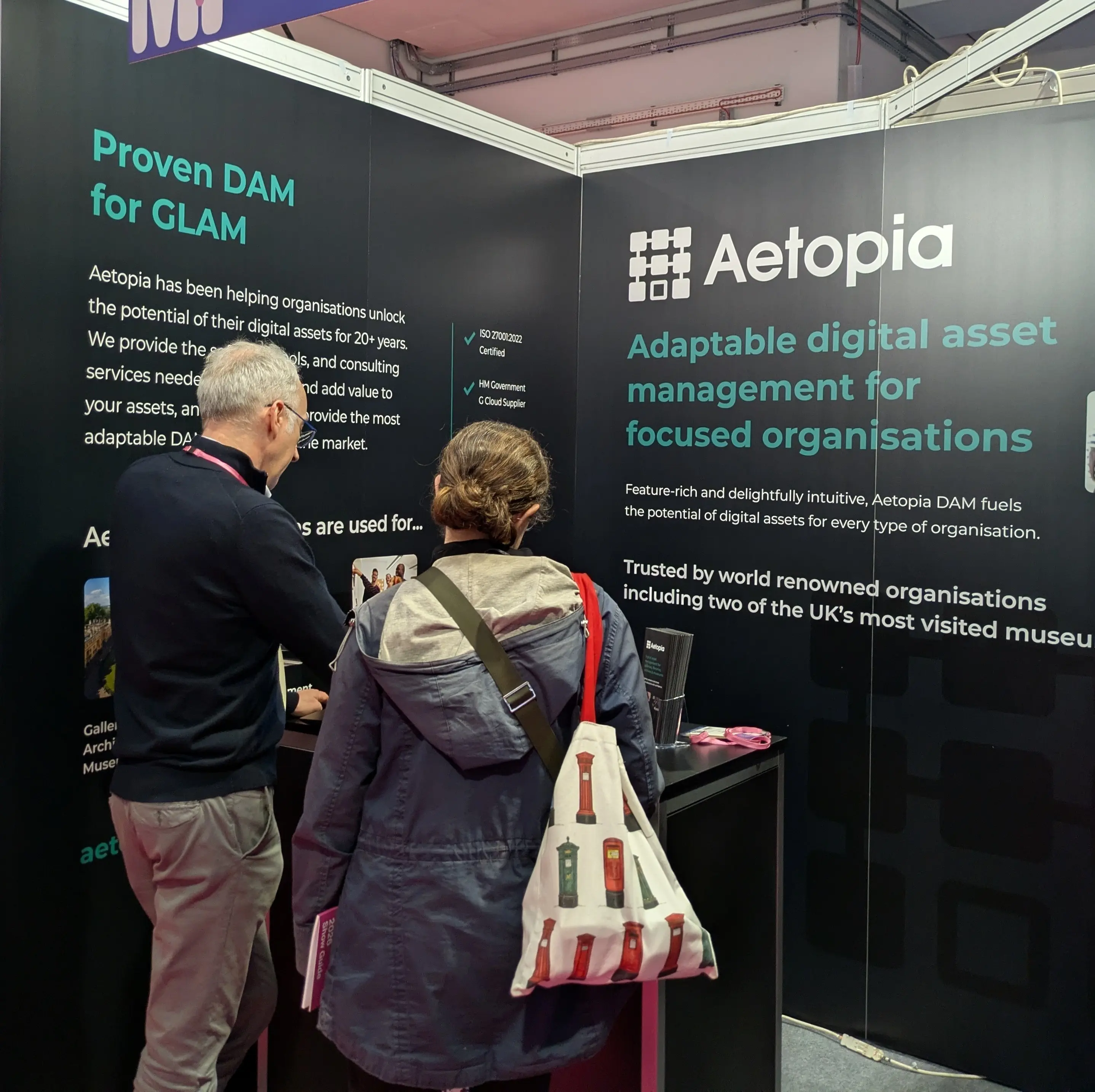 Aetopia team member demonstrating the platform to a visitor at Stand W14, Museums + Heritage Show 2026